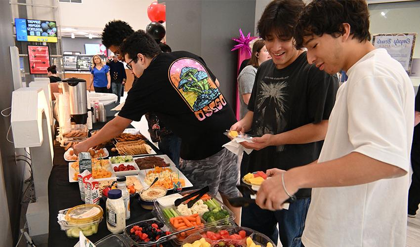 Students enjoying the snacks from the art exposition.